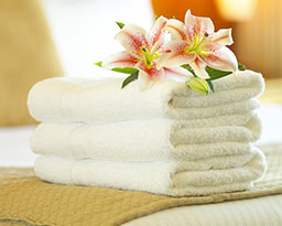 Folded towels with flowers on top.